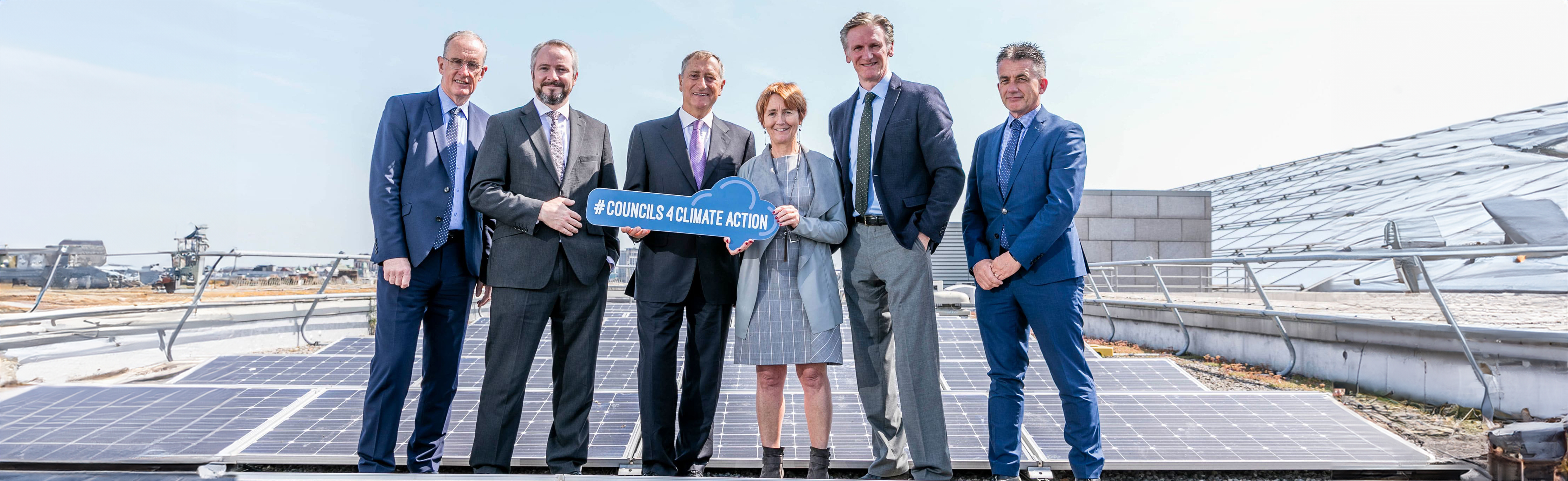 Dublin City Council sustainability team beside new rooftop solar panels