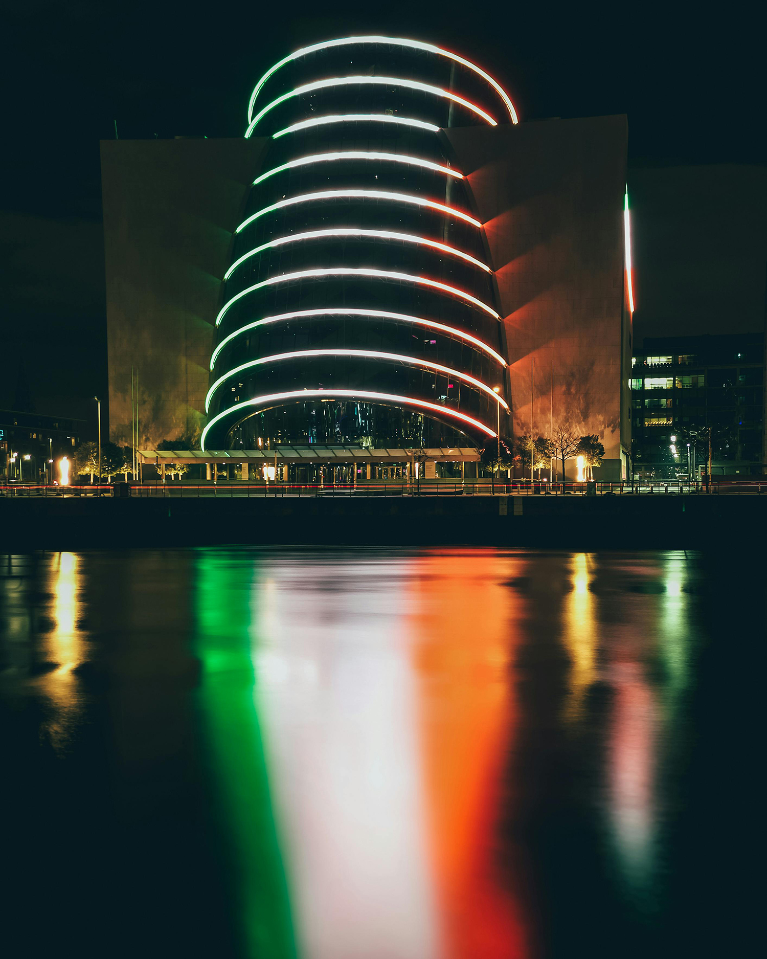 Dublin City national conference centre, with lights reflected in the river Liffey