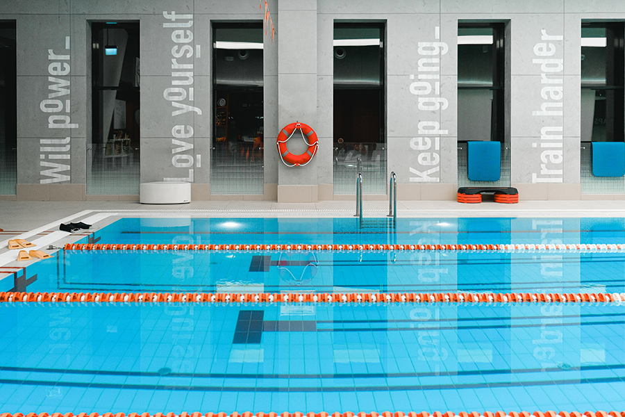 An empty public swimming pool with swim lanes marked by floats.