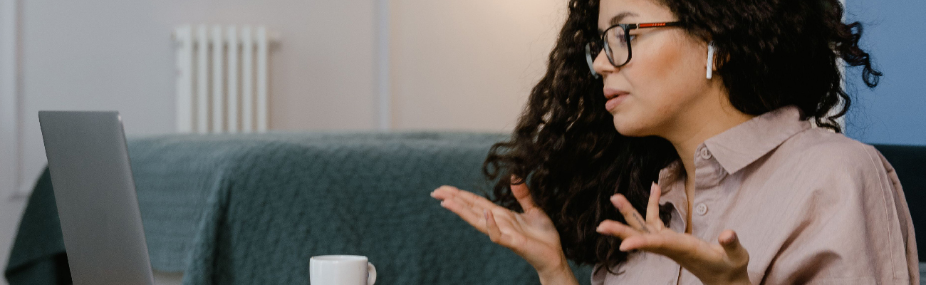 A woman discussing a technical support issue over a video call.
