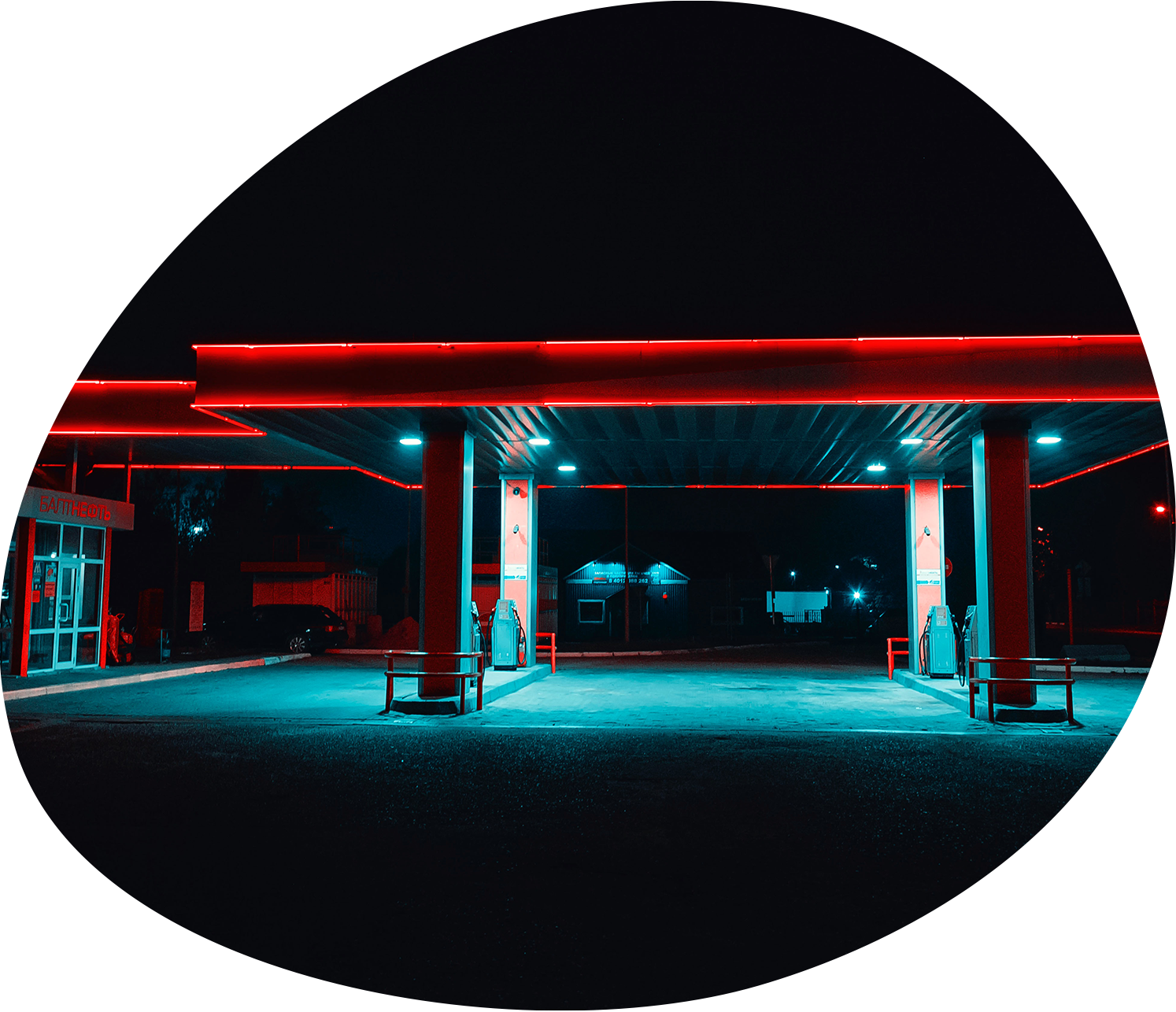 A brightly lit filling station forecourt at night