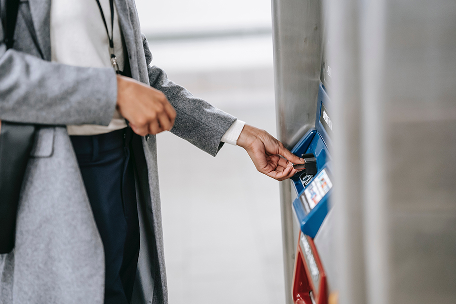 Someone withdrawing money from an automated teller machine (ATM).